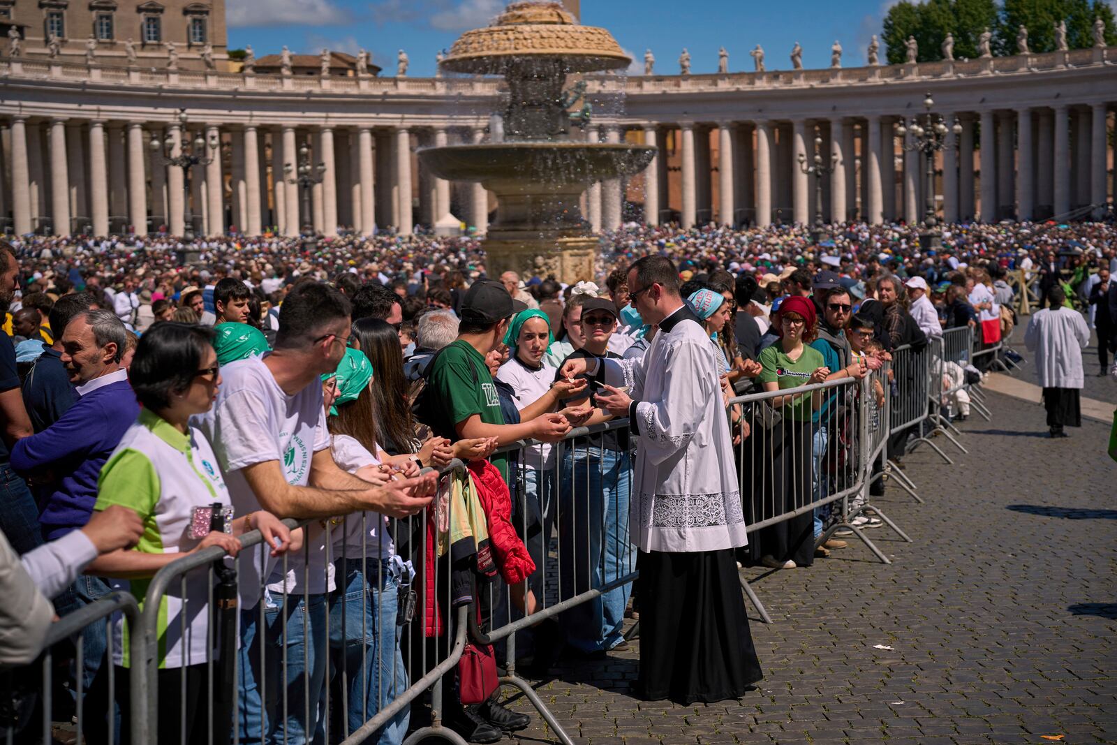 Faithful receive communion during the funeral of Pope Francis in St. Peter's Square at the Vatican, Saturday, April 26, 2025. (AP Photo/Emilio Morenatti)