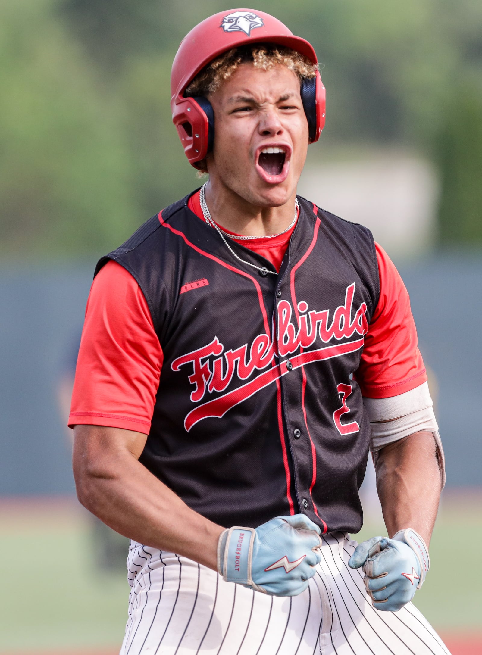 Lakota West senior catcher Braydon Johnson celebrates after a triple in the fifth inning of a Division I regional final against Cincinnati Moeller on Wednesday at Wright State University's Nischwitz Stadium. BRYANT BILLING / STAFF