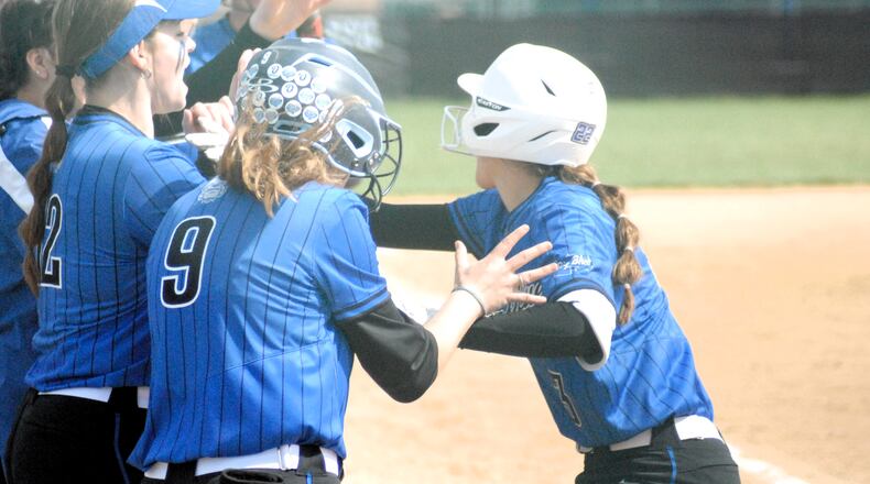 Hamilton's Emili Schappacher (right) is congratulated by her teammates at home plate after hitting a two-run homer against Badin on Saturday. Chris Vogt/CONTRIBUTED
