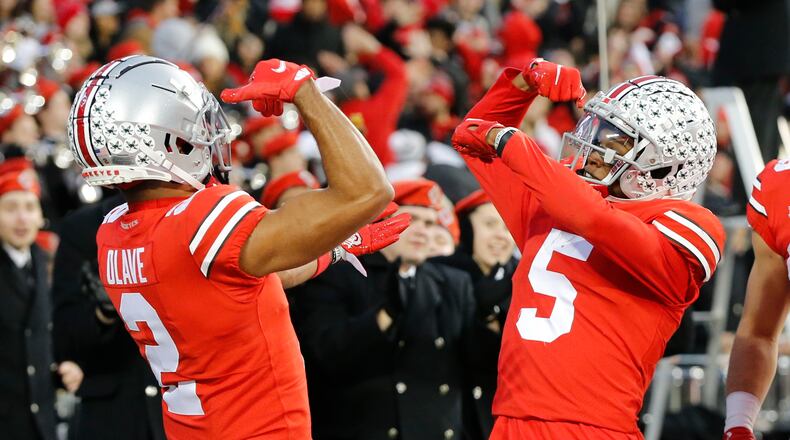 Ohio State receiver Garrett Wilson, right, celebrates his touchdown against Purdue with teammate Chris Olave during the first half of an NCAA college football game, Saturday, Nov. 13, 2021, in Columbus, Ohio. (AP Photo/Jay LaPrete)