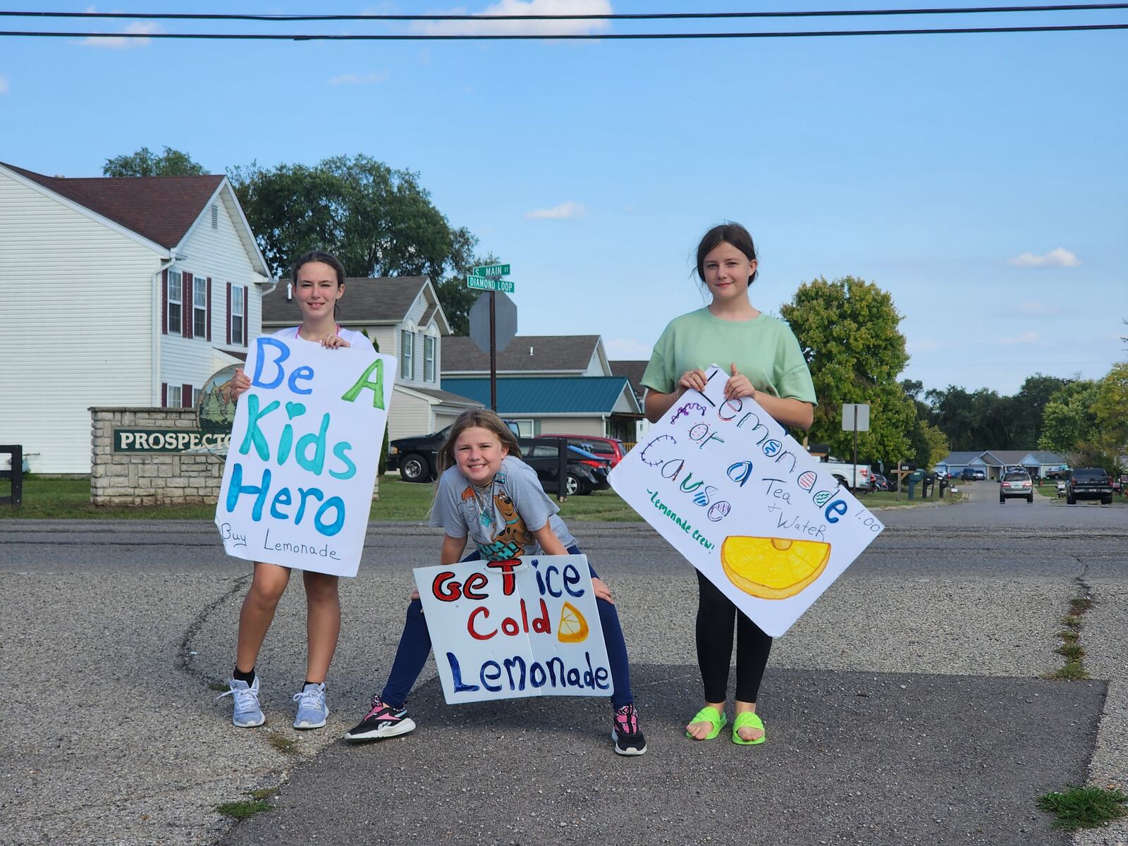 Three of the four members of the Lemonade Crew try to entice people to buy their lemonade. From left, Terre Merrill, Aria Merrill and Emma Merrill. SUBMITTED PHOTO