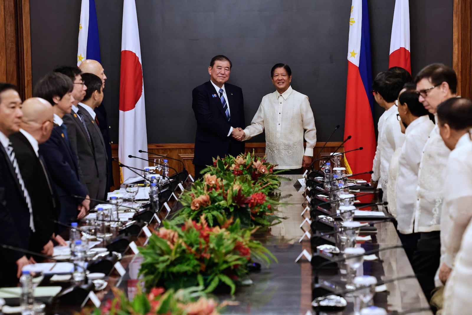 Japan's Prime Minister Shigeru Ishiba, center left, and Philippines President Ferdinand Marcos Jr. shake hands before the start of a bilateral meeting at Malacanang Palace in Manila, Philippines Tuesday, April 29, 2025. (Rolex Dela Pena/Pool Photo via AP)
