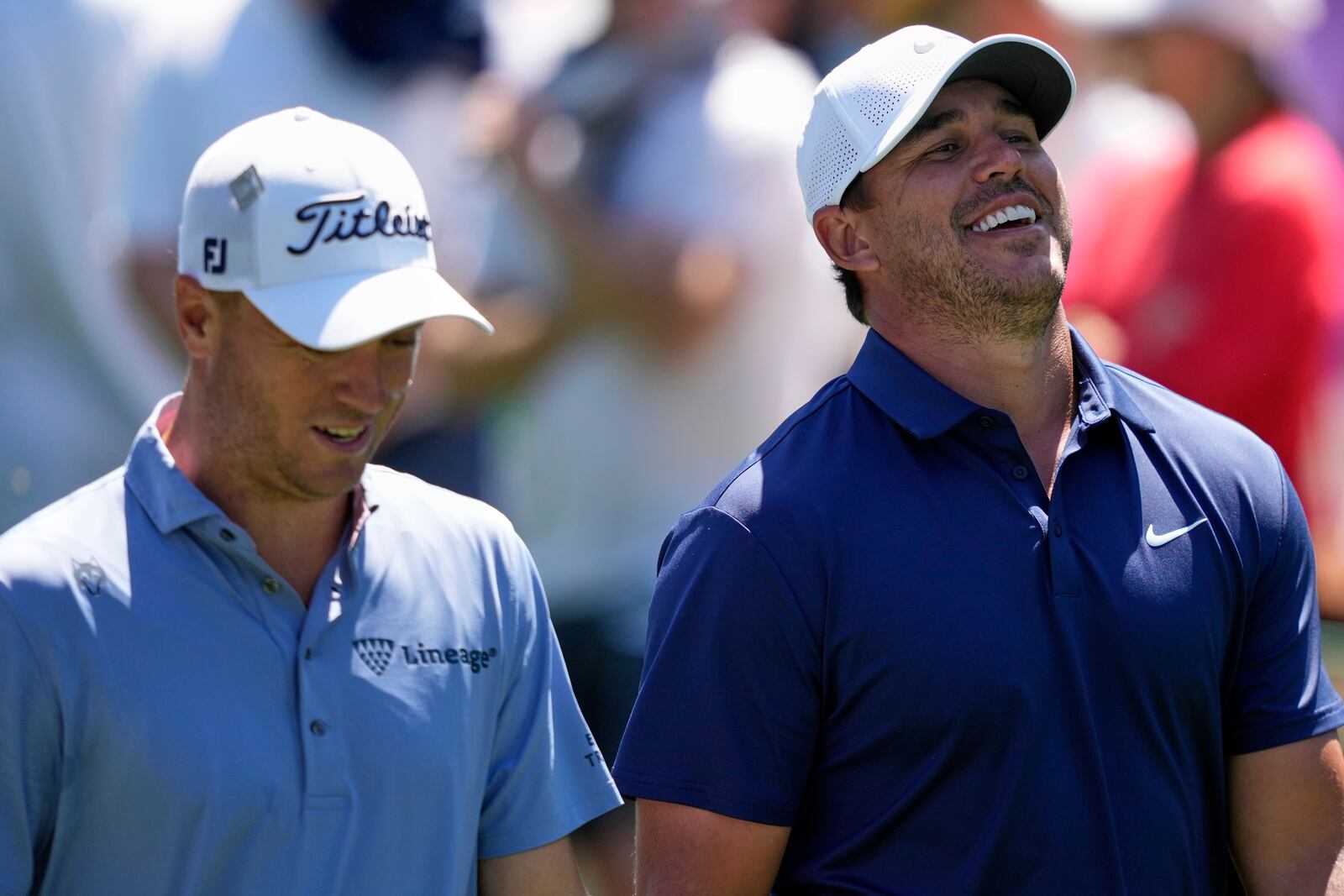 Brooks Koepka laughs while talking with Justin Thomas, left, on the 15th fairway during a practice round at the Masters golf tournament, Tuesday, April 8, 2025, in Augusta, Ga. (AP Photo/Matt Slocum)
