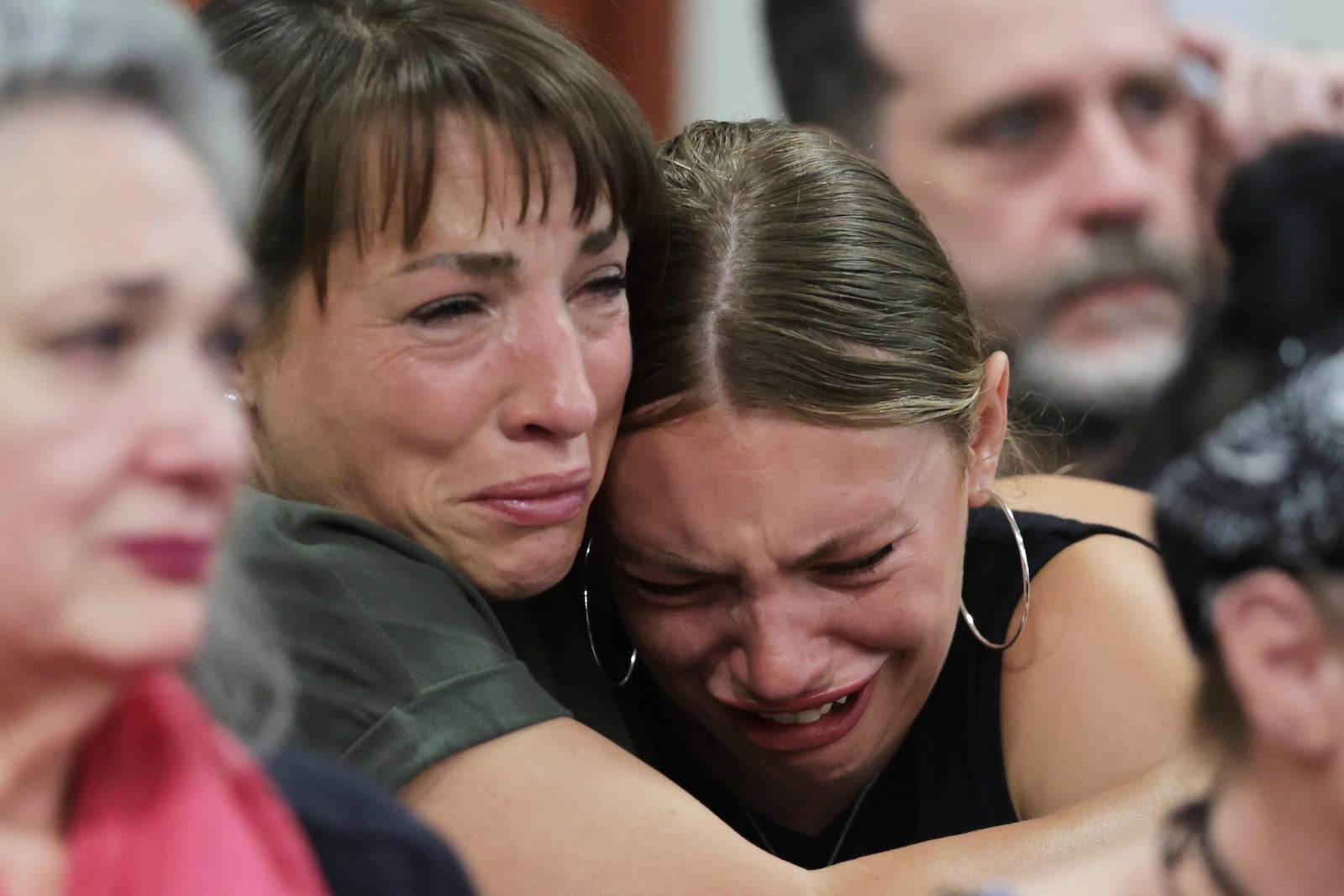 Dylan Mortensen gets a hug after speaking at the sentencing hearing of Bryan Kohberger at the Ada County Courthouse, for his sentencing hearing, Wednesday, July 23, 2025, in Boise, Idaho, for brutally stabbing four University of Idaho students to death nearly three years ago. (AP Photo/Kyle Green, Pool)