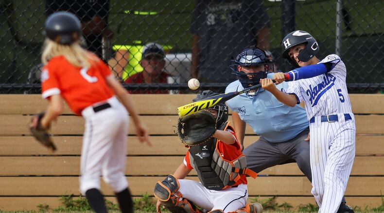 Hamilton's Blake Sams makes contact with the ball during Hamilton West Side Little League's 10-1 win over Loveland in the District 9 Little League championship Monday, July 11, 2022 at Home of the Brave Park in Loveland. NICK GRAHAM/STAFF