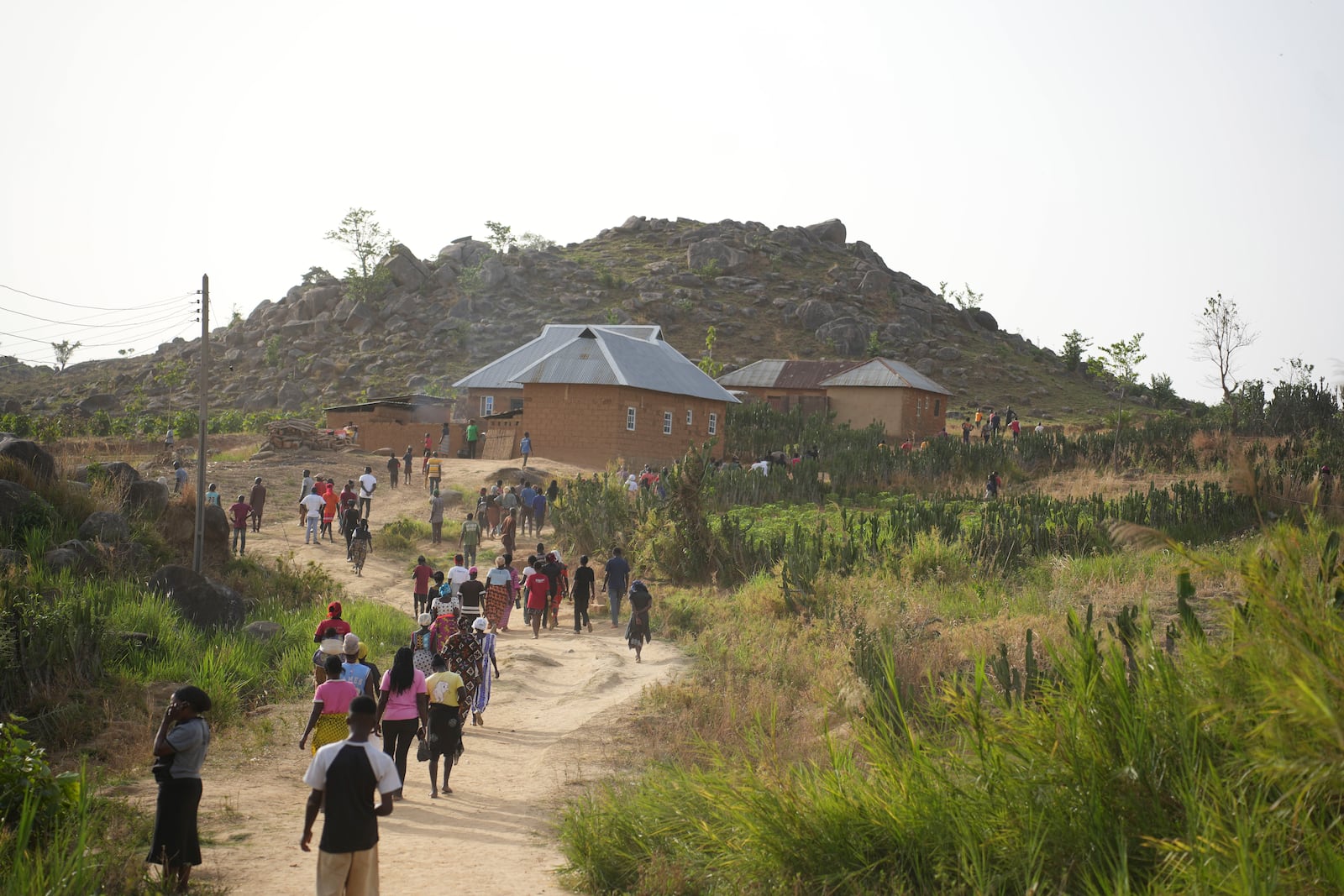 People prepare for the funeral of a man that was killed following an attack by gunmen in the Zike farming community in north-central Nigeria, Tuesday, April 15, 2025. (AP Photo/Samson Omale)