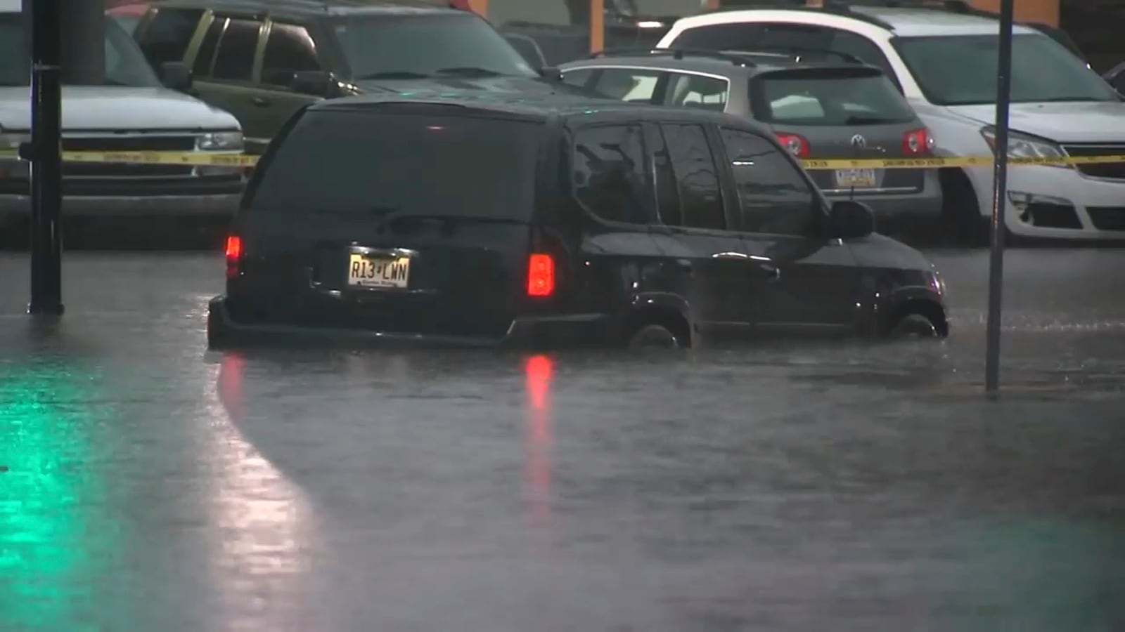 This image made from video shows cars submerged in floodwaters in Rahway, NJ., on July 14, 2025.(WABC-TV via AP)