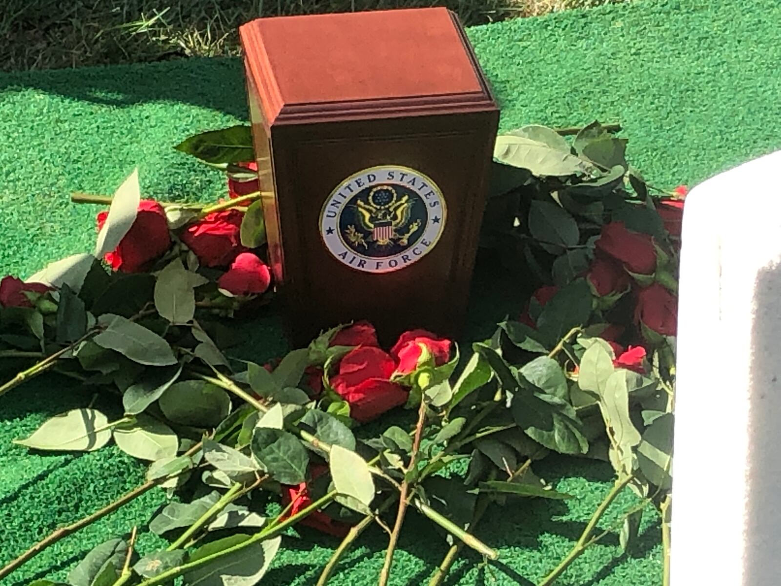 The remains of Maris McCrabb, who served 25 years in the U.S. Air Force, are surrounded by red roses placed by his family. He was buried last week at Arlington National Cemetery. RICK McCRABB/STAFF