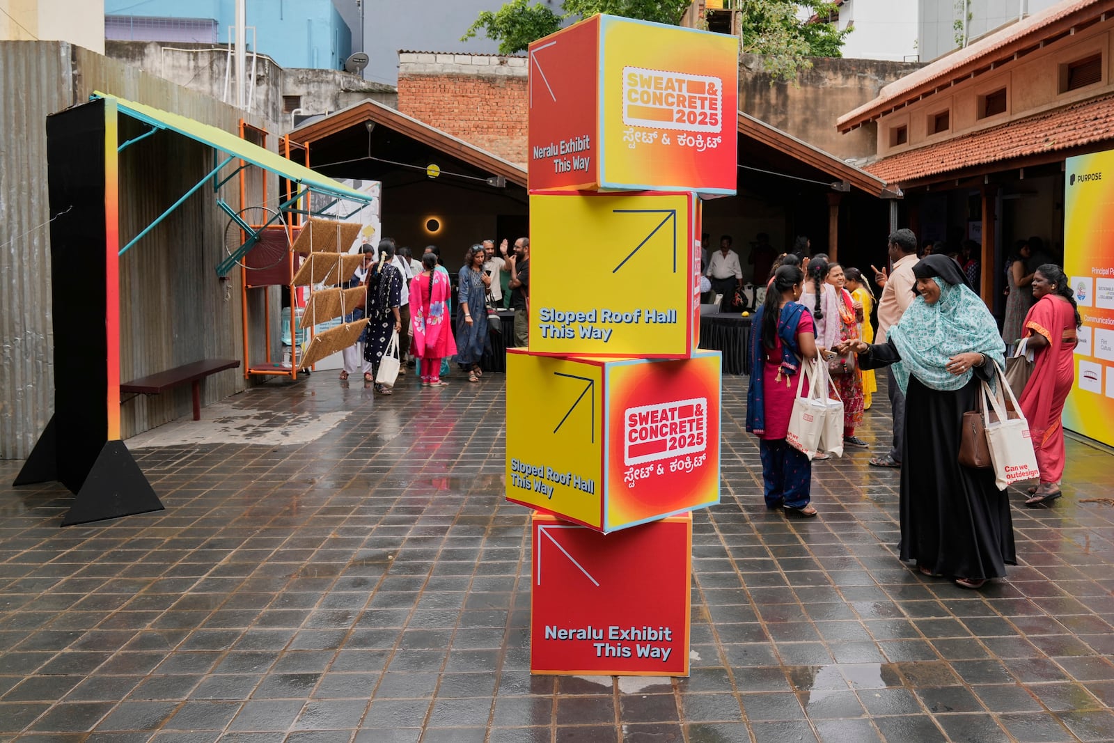 Daily wage workers, who mostly work outdoors, leave after exploring Neralu, an innovative portable heat shelter, at the Sweat and Concrete 2025 event in Bengaluru, India, Thursday, May 29, 2025. (AP Photo/Aijaz Rahi)