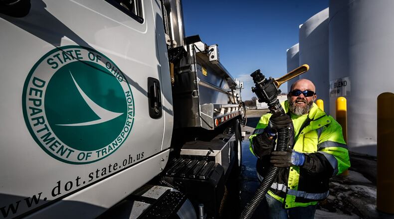 ODOT snowplow driver Rob Gardner pumps an 80/20 brine mixture into his truck in this file photo from last winter. Road crews from ODOT and local cities and counties are ready for winter weather, even if there hasn't been as much of it lately. JIM NOELKER/STAFF