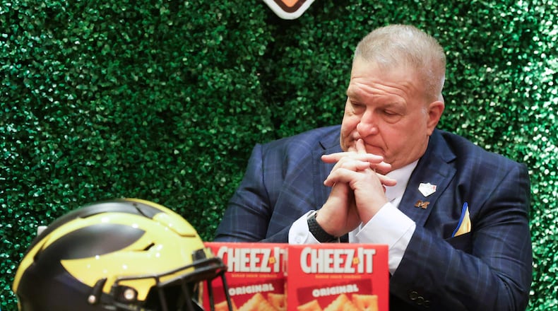 Michigan interim head coach Biff Poggi pauses after an NCAA college football Citrus Bowl news conference in Winter Park, Fla., Monday, Dec. 15, 2025, ahead of his team's New Year's Eve appearance against Texas in the bowl in Orlando, Fla. (Joe Burbank/Orlando Sentinel via AP)