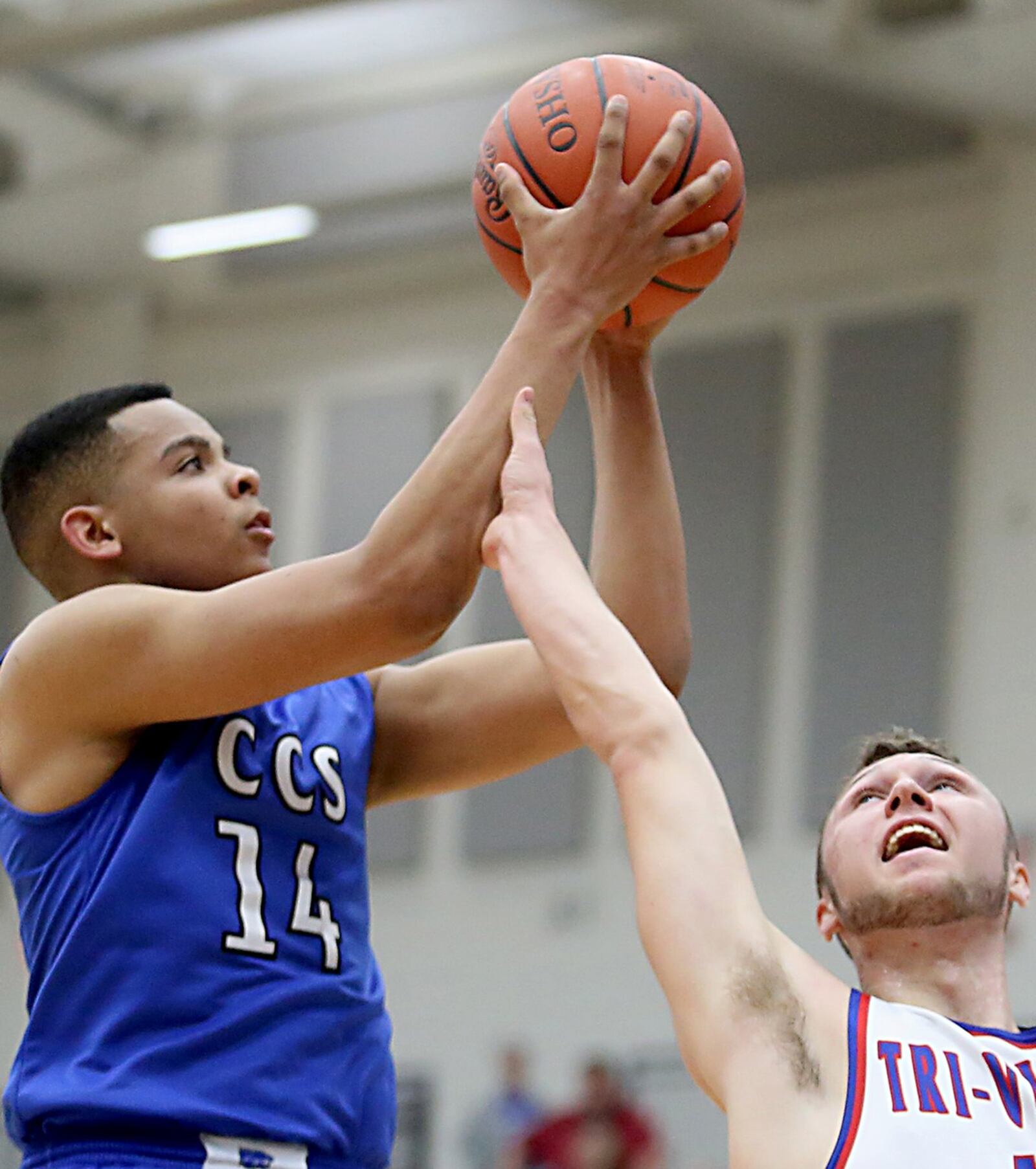 Cincinnati Christian’s Christian Keese scores over New Madison Tri-Village’s Jonny Wilson on Tuesday night during their Division IV regional semifinal at Fairmont’s Trent Arena. CONTRIBUTED PHOTO BY E.L. HUBBARD