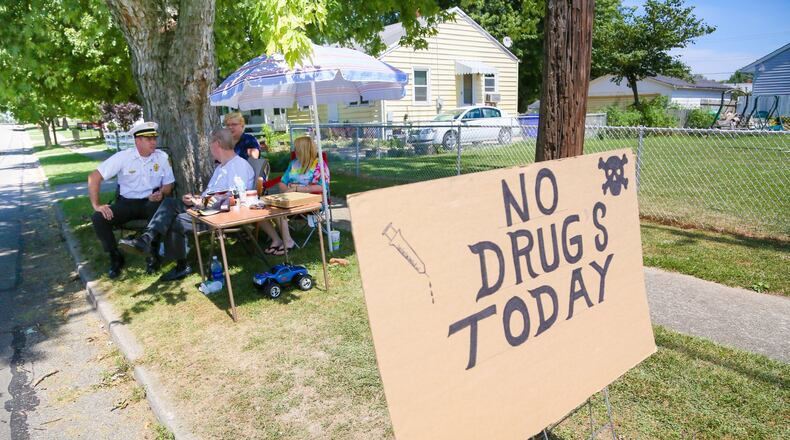 The “No Drugs Today” campaign by Parkamo Avenue resident Denny Matheny helped spur Hamilton’s East End neighborhood to organize. During his outdoor sit-in last summer, Matheny, who was angered about drug dealing in the neighborhood, was joined throughout the day by various neighbors, family members, and Hamilton Police Chief Craig Bucheit. GREG LYNCH / STAFF