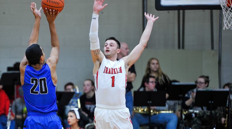 Franklin’s Brayden Hall goes after a shot by Brookville’s Manny Willis during Friday night’s game at Darrell Hedric Gym in Franklin. The host Wildcats won 72-68 in overtime. NICK GRAHAM/STAFF