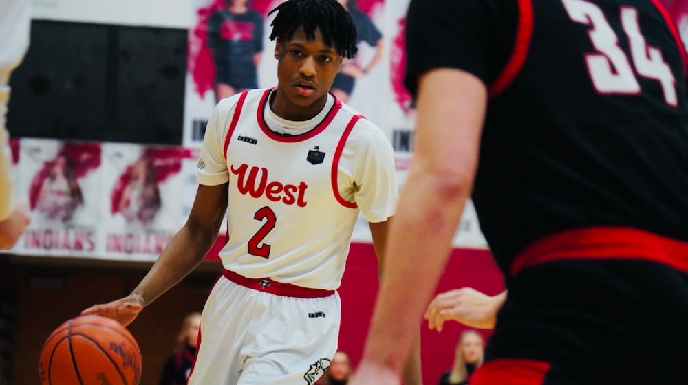 Lakota West guard Joshua Tyson (2) dribbles the ball while being guarded by Oak Hills forward Gabe Cox (34) on Friday night at Fairfield Arena. CHRIS VOGT / CONTRIBUTED