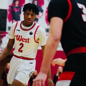 Lakota West guard Joshua Tyson (2) dribbles the ball while being guarded by Oak Hills forward Gabe Cox (34) on Friday night at Fairfield Arena. CHRIS VOGT / CONTRIBUTED