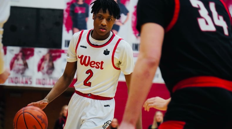 Lakota West guard Joshua Tyson (2) dribbles the ball while being guarded by Oak Hills forward Gabe Cox (34) on Friday night at Fairfield Arena. CHRIS VOGT / CONTRIBUTED