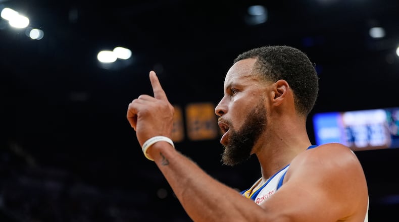 Golden State Warriors guard Stephen Curry reacts after scoring during the second half of an NBA basketball game against the Denver Nuggets, Thursday, Oct. 23, 2025, in San Francisco. (AP Photo/Godofredo A. Vásquez)
