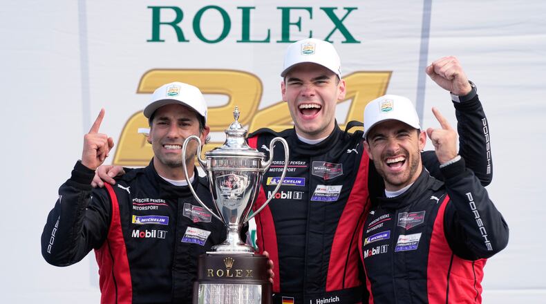 Winners of the Rolex 24 hour auto race, from left, Felipe Nasr, of Brazil, Laurin Heinrich, of Germany and Julien Andlauer, of France celebrate with the championship trophy in Victory Lane at Daytona International Speedway, Sunday, Jan. 25, 2026, in Daytona Beach, Fla. (AP Photo/John Raoux)
