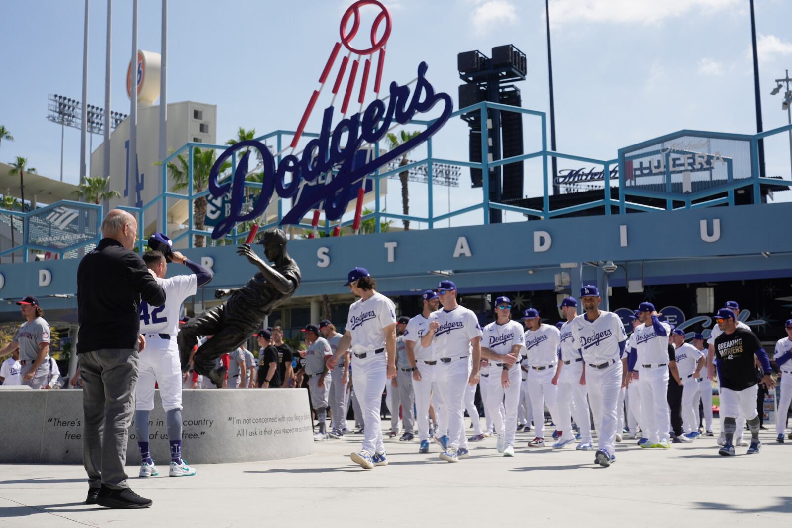 FILE - Los Angeles Dodgers and Washington Nationals team members arrive to celebrate Jackie Robinson Tribute Day before a baseball game at Dodger Stadium in Los Angeles, on Monday, April 15, 2024. (AP Photo/Damian Dovarganes, File)