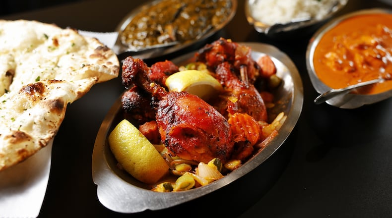 OM India on Wessel Drive in Fairfield was voted best Indian restaurant in the Journal-News Best of Butler County 2023. This is their garlic naan, chicken tandoori, chicken tikka Masala, basmati rice and saag paneer. NICK GRAHAM/STAFF