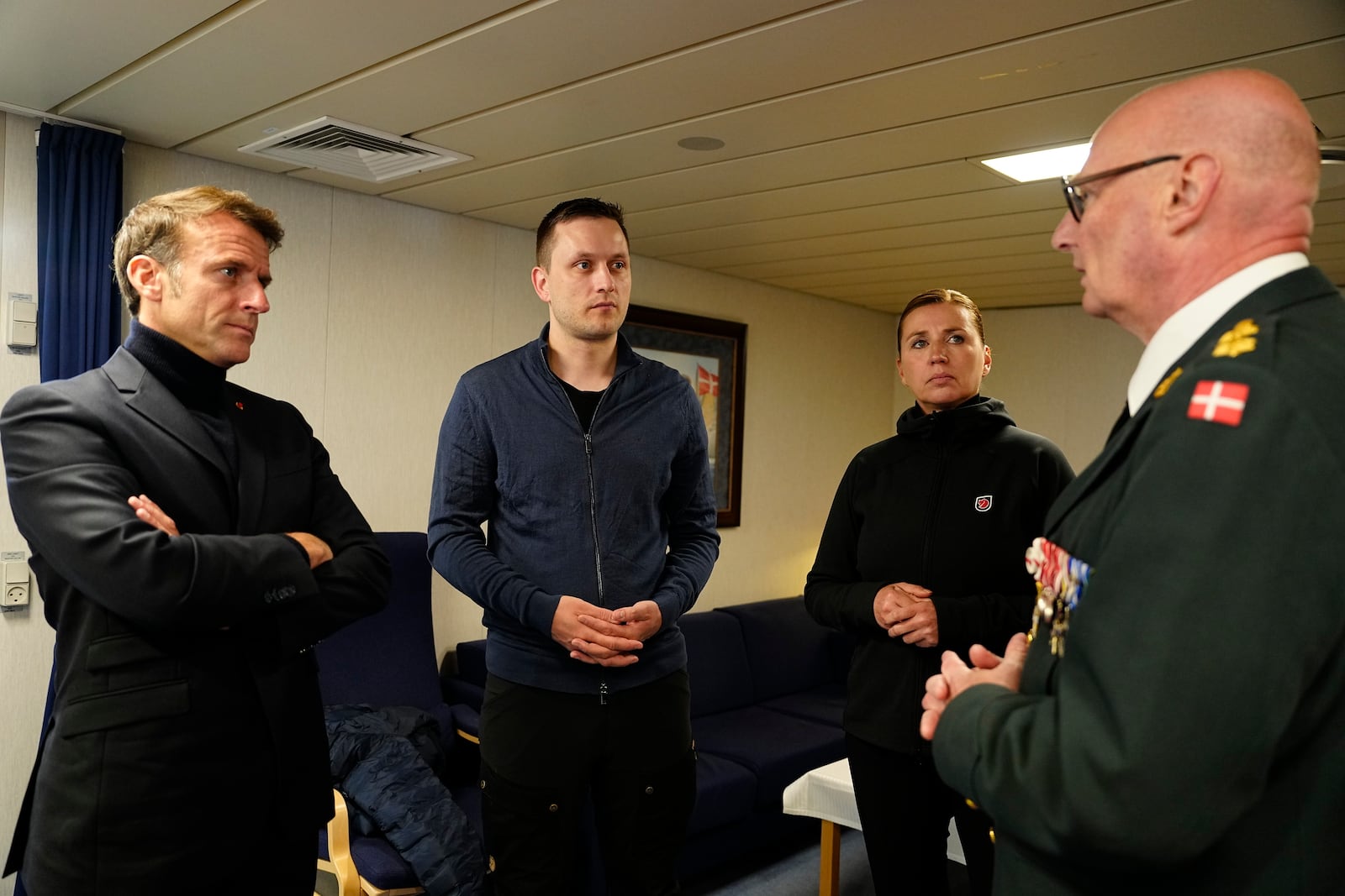 French President Emmanuel Macron, Danish Prime Minister Mette Frederiksen, and Greenlandic Prime Minister Jens-Frederik Nielsen are briefed by Major General, Chief of Arctic Command Soeren Andersen aboard the Danish frigate F363 Niels Juel in Nuuk, Greenland, on Sunday, June 15, 2025. (Mads Claus Rasmussen/Scanpix via AP)