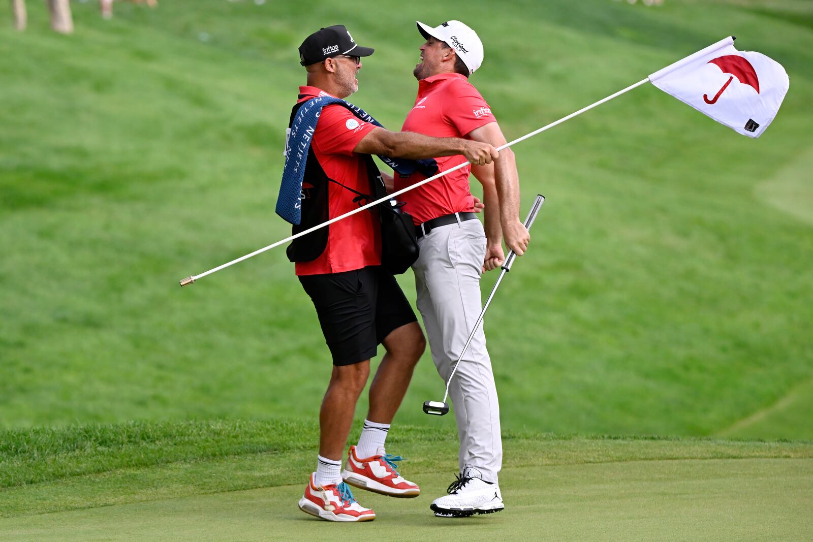 Keegan Bradley, right, chest bumps his caddie Scott Vail, left, in celebration after winning of the Travelers Championship golf tournament at TPC River Highlands, Sunday, June 22, 2025, in Cromwell, Conn. (AP Photo/Jessica Hill)