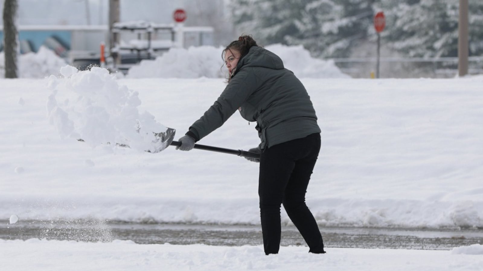 Ceiran Deck, an employee at Meijer Express Gas Station in Troy, shovels snow on the station's tank farm on Tuesday, Dec. 2. Troy received over five inches of snow. BRYANT BILLING/STAFF