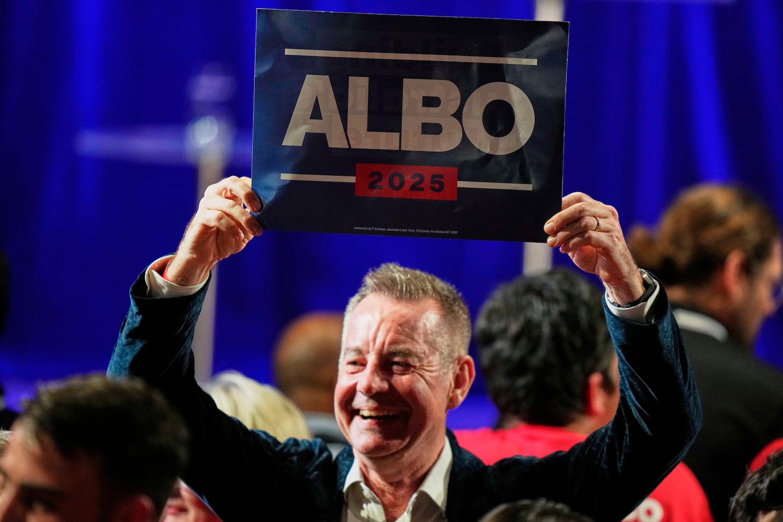 A Labor Party supporter reacts as he watches results shown on a screen at their party headquarters in Sydney, Saturday, May 3, 2025. (AP Photo/Rick Rycroft)