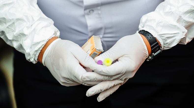 Capt. David Von Bargen, with Middletown Division of Fire, unboxes Narcan as Middletown paramedics and police officers responded to a drug overdose in June in Middletown. NICK GRAHAM/STAFF