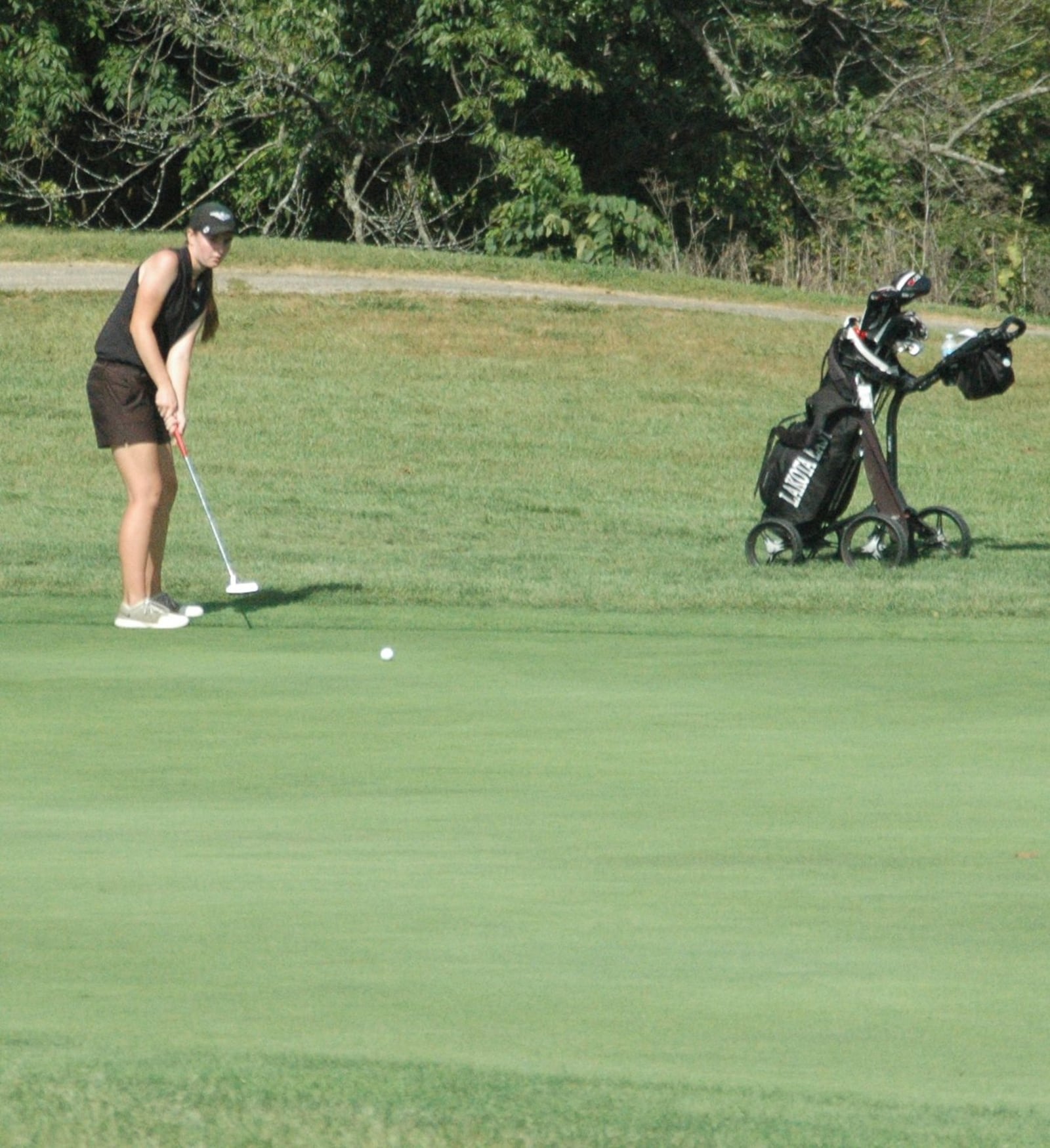 Lakota East’s Grace Honigford watches a putt on her final hole of the day Tuesday during the Division I district girls golf tournament at Glenview Golf Course. RICK CASSANO/STAFF