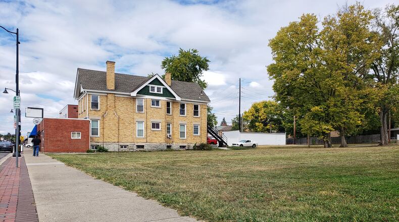 Hamilton plans to buy the property in the background in the 300 block of Main Street so a developer can build a 50-plus apartment complex without tearing down the historic double residence to the east (not shown) that residents asked Hamilton City Council to spare. NICK GRAHAM/STAFF