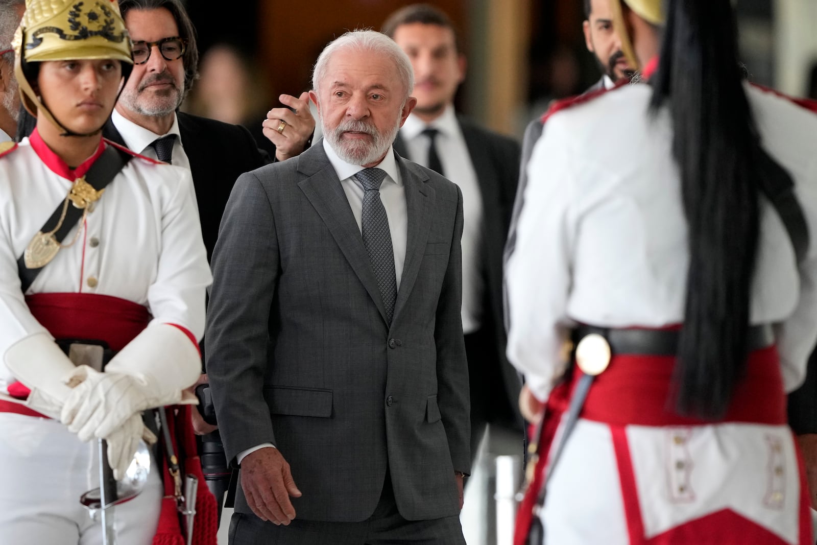 Brazil's President Luiz Inacio Lula da Silva walks among presidential guards during an event at the Planalto presidential palace in Brasilia, Brazil, Wednesday, July 9, 2025. (AP Photo/Eraldo Peres)