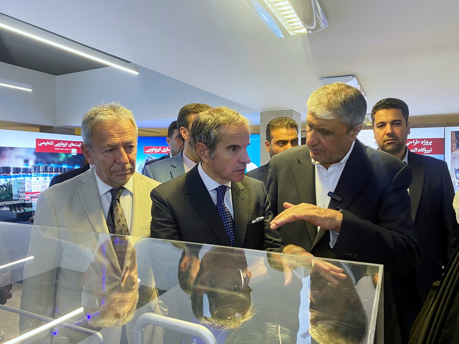 In this photo released by the Atomic Energy Organization of Iran, International Atomic Energy Agency (IAEA) Director General, Rafael Mariano Grossi, center, listens to head of the Atomic Energy Organization of Iran Mohammad Eslami as he visits an exhibition of Iran's nuclear achievements, in Tehran, Iran, Thursday, April 17, 2025. (Atomic Energy Organisation of Iran via AP)