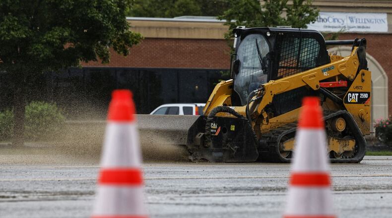 West Chester Twp. crews are cleaning up a portion of Union Centre Boulevard after a truck was traveling and leaking hydraulic fluid on the road between West Chester and Beckett roads. NICK GRAHAM/STAFF