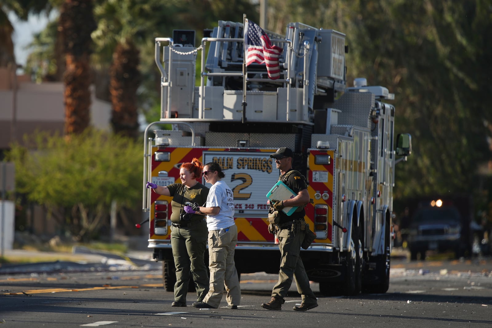 Investigators walk the on the scene of an explosion Saturday, May 17, 2025, in Palm Springs, Calif. (AP Photo/Eric Thayer)