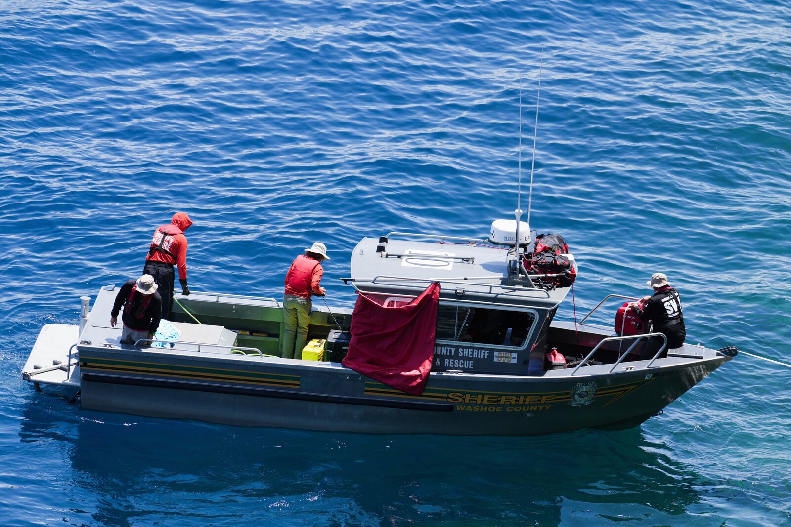Washoe County Sheriffs conduct a search at D.L. Bliss State Park after a weekend incident in which a boat capsized, killing several people, on Monday, June 23, 2025, in Lake Tahoe, Calif. (AP Photo/Brooke Hess-Homeier)