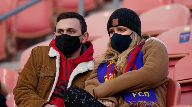Real Salt Lake fans wearing masks wait for the team's MLS soccer match against Los Angeles FC on Wednesday, Sept. 9, 2020, in Sandy, Utah. (AP Photo/Rick Bowmer)