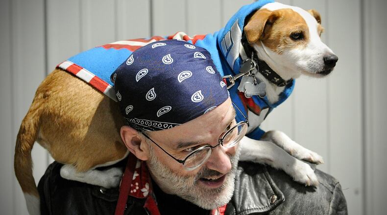 Tom Sobczak and his dog Tikis have fun at The Great Ohio Toy Show in Xenia. Loud fireworks disturb many pets, but animal experts say there are steps to keep them safe. MARSHALL GORBY/STAFF