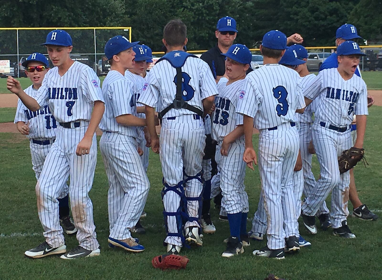 Hamilton West Side’s players break from the postgame huddle Thursday night after defeated Galion 15-1 in the Ohio Little League Tournament at the Hoover Community Recreation Complex in North Canton. RICK CASSANO/STAFF