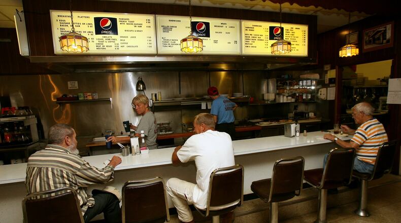 Customers sit at the bar during lunch Friday, May 13, 2011, at Ohio Lunch in downtown Hamilton. The restaurant, like others, since has closed, partly because owners could not afford to upgrade kitchen hoods to meet modern building-code standards. FILE