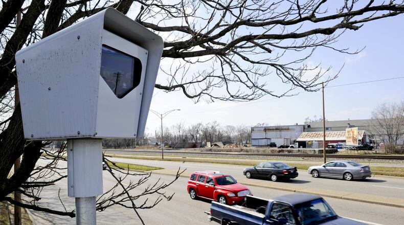 Vehicles pass by a red light camera in Middletown.