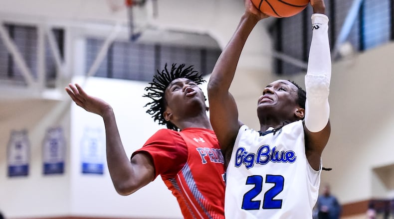 Hamilton’s Ke’Von Burnett goes to the hoop defended by Princeton’s Greg Johnson during Friday night’s game at the Hamilton Athletic Center. Princeton won 44-43. NICK GRAHAM/STAFF