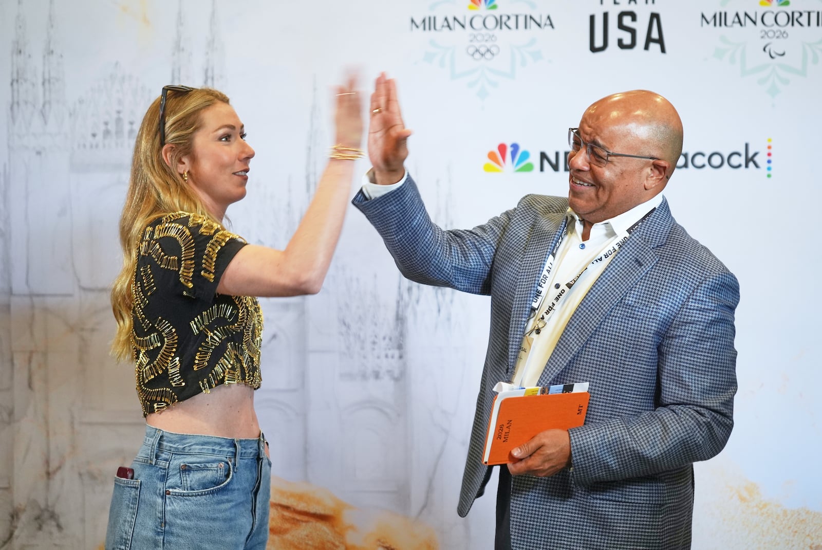 Mikaela Shiffrin, U.S. World Cup alpine skier left, and Mike Tirico, NBC Olympics primetime host meet at a NBCUniversal and U.S. Olympic & Paralympic Committee press preview event to promote the upcoming Milano Cortina 2026 Olympic and Paralympic Winter Games, in Los Angeles Wednesday, May 21, 2025. (AP Photo/Damian Dovarganes)