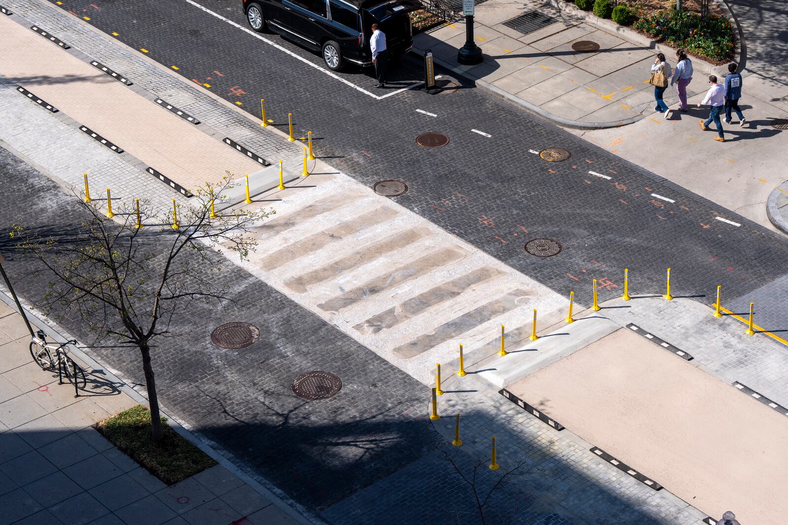Pedestrians and traffic use 16th Street NW, after Black Lives Matter Plaza has been re-done eliminating the tribute, Tuesday, April 1, 2025, in Washington. (AP Photo/Alex Brandon)