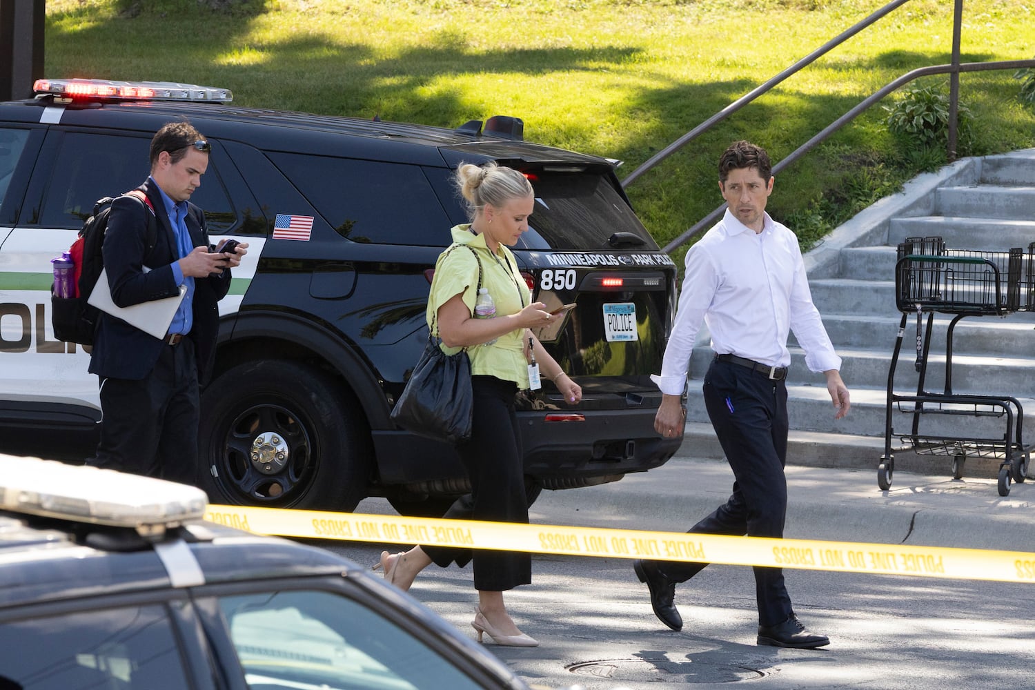 Mayor Jacob Frey of Minneapolis exits the scene of a shooting at the Annunciation Catholic Church in Minneapolis, on Wednesday, Aug. 27, 2025. An assailant fired a rifle through the windows of the Catholic church  where students were celebrating their first Mass of the new school year on Wednesday, killing an 8-year-old and a 10-year-old in the pews and injuring 17 others, the police said. (Liam James Doyle/The New York Times)