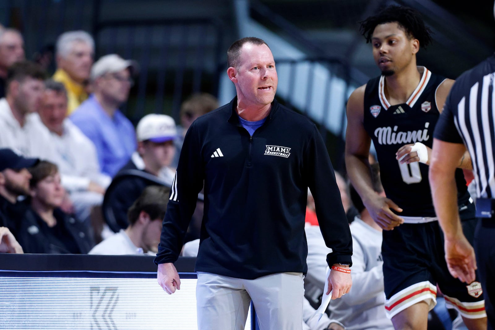 Miami (Ohio) coach Travis Steele, center, reacts during the first half of an NCAA college basketball game against Western Michigan, Friday, Feb. 27, 2026, in Kalamazoo, Mich. (AP Photo/Al Goldis)