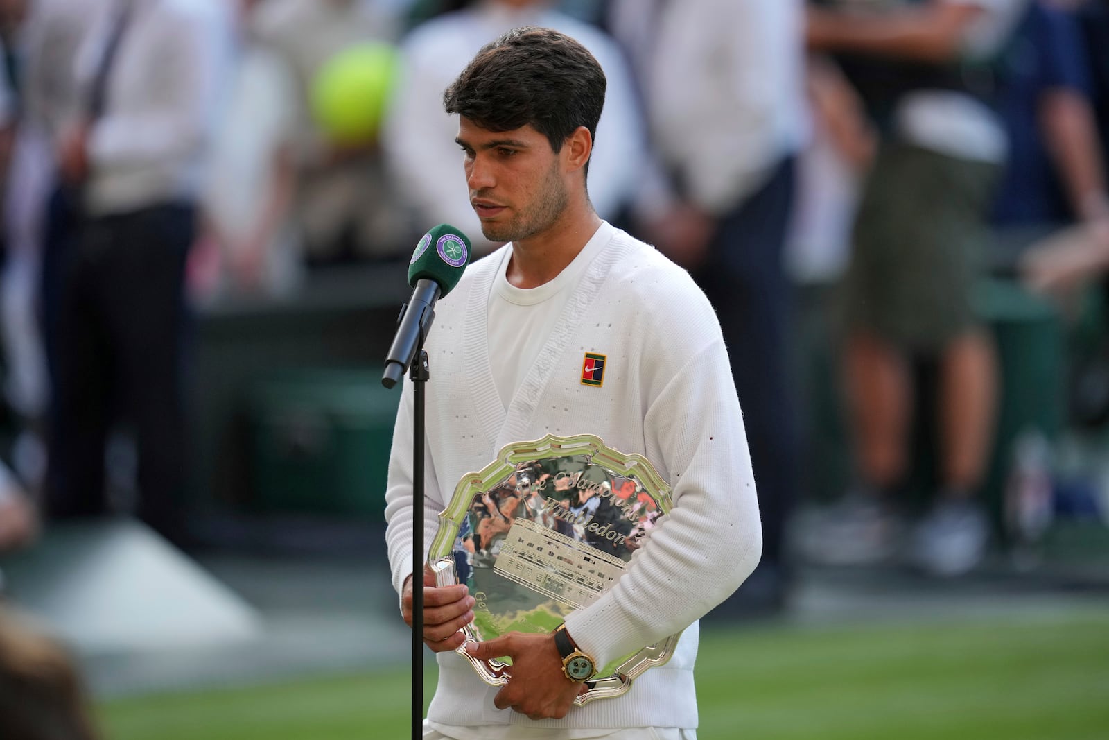 Carlos Alcaraz of Spain is interviewed holding his runners-up trophy after losing to Italy's Jannik Sinner in the men's singles final at the Wimbledon Tennis Championships in London, Sunday, July 13, 2025. (AP Photo/Kin Cheung)