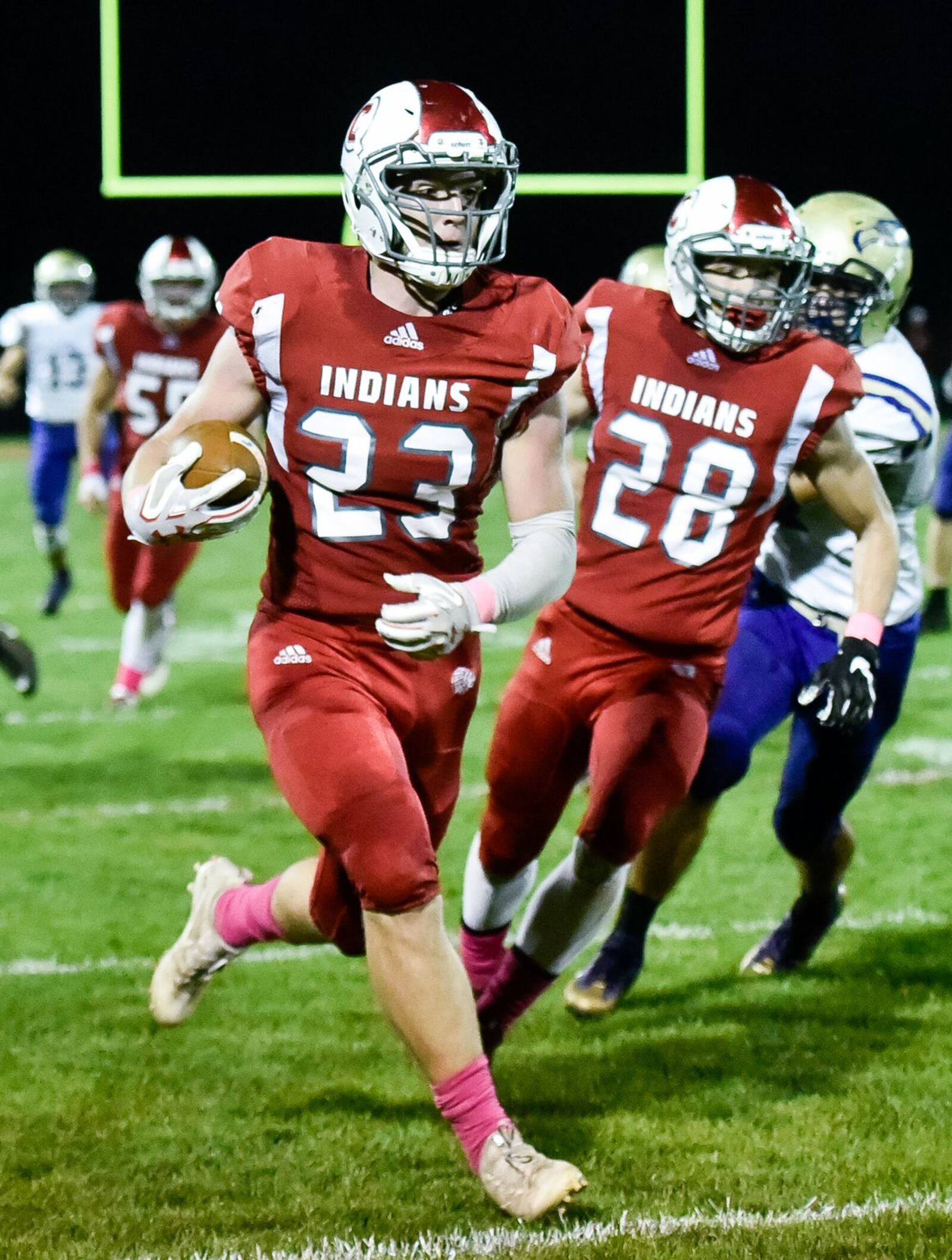 Carlisle’s Spencer Mays carries the ball as teammate Dane Flatter (28) trails the play during Thursday night’s game against Eaton at Laughlin Field in Carlisle. NICK GRAHAM/STAFF