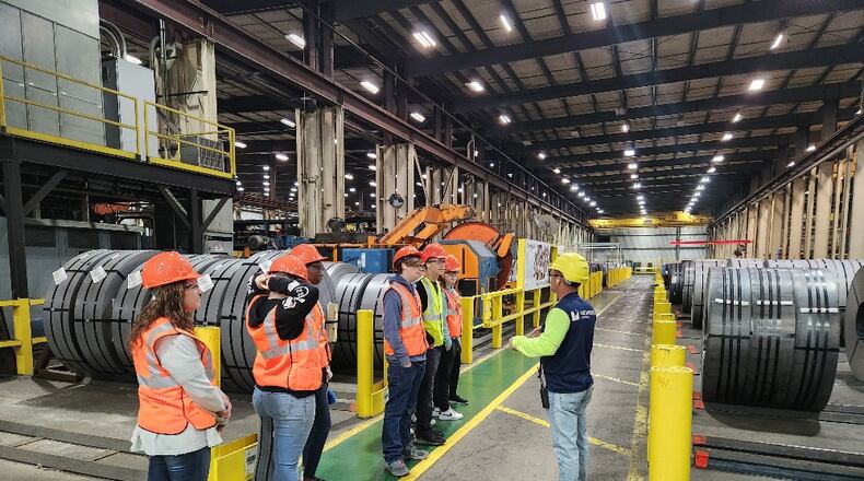A representative from Worthington Industries gives students a tour during one of the National Manufacturing Day/Month programs celebrated by the Chamber of Commerce serving Middletown, Monroe and Trenton. SUBMITTED PHOTO